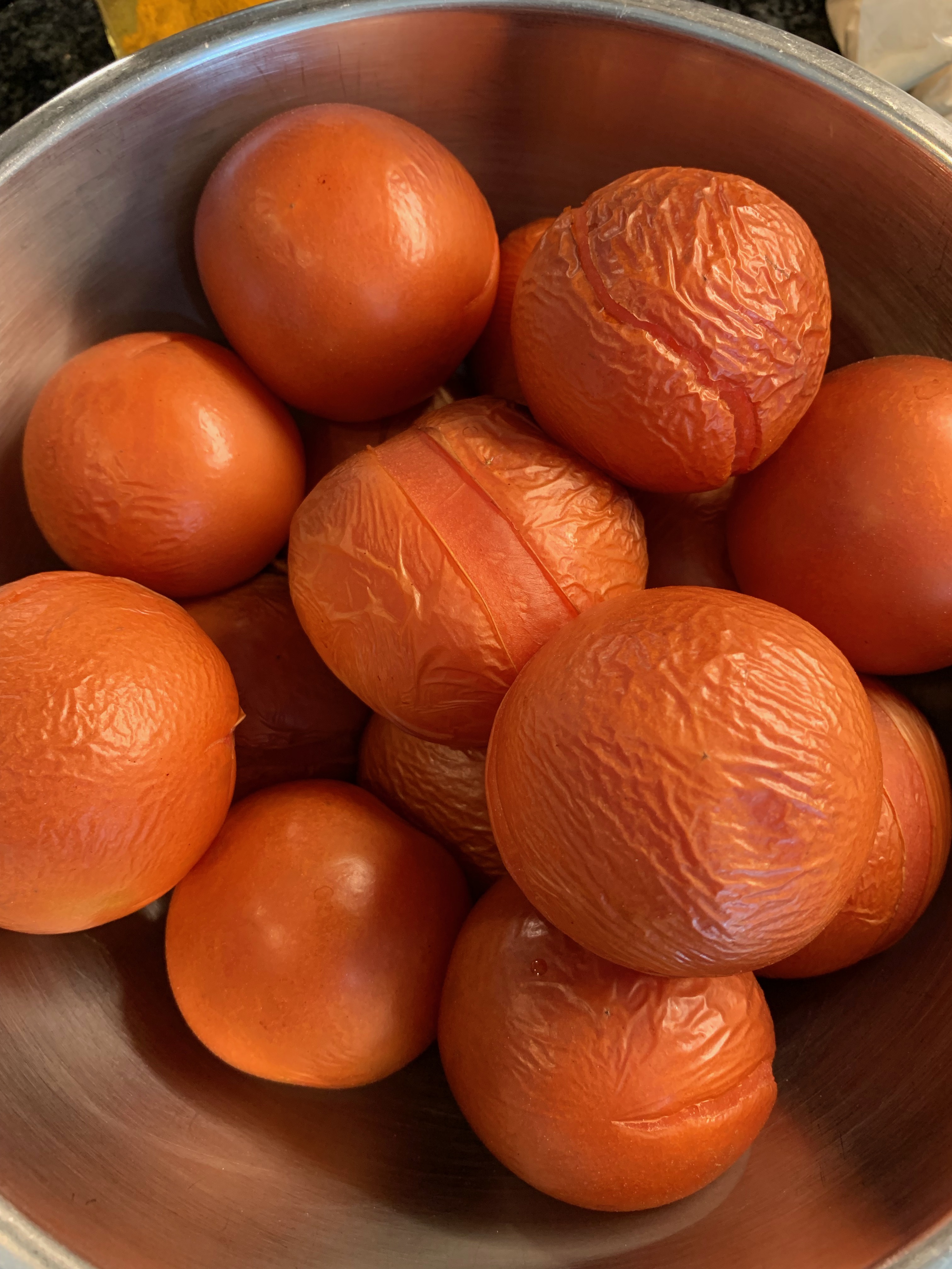 Charred, blistered tomatoes collected in a bowl